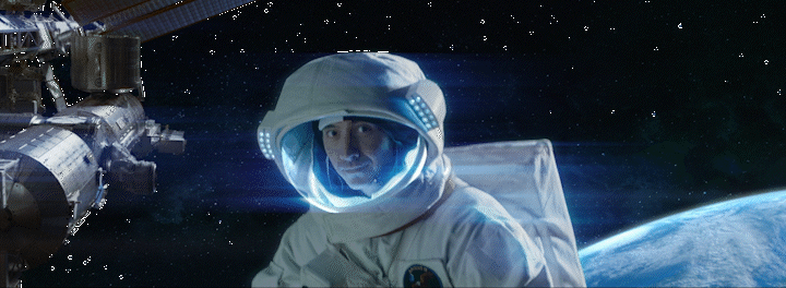 a man in a space suit next to a space station