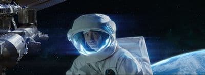 a man in a space suit next to a space station