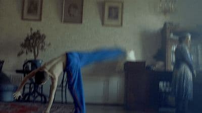 a person doing a handstand in a living room