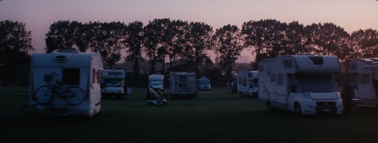 a group of rvs parked next to each other in a field