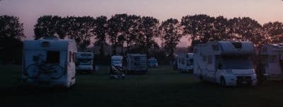 a group of rvs parked next to each other in a field