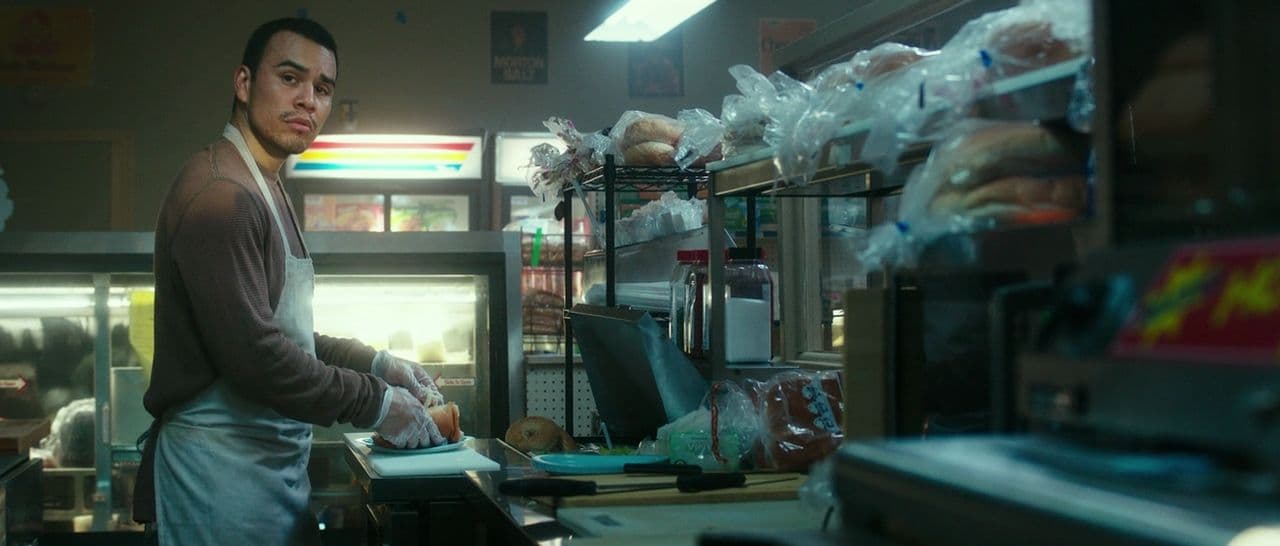 a man standing in a kitchen next to a counter