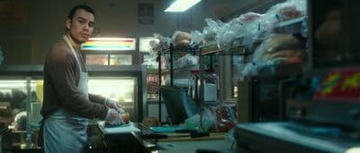 a man standing in a kitchen next to a counter