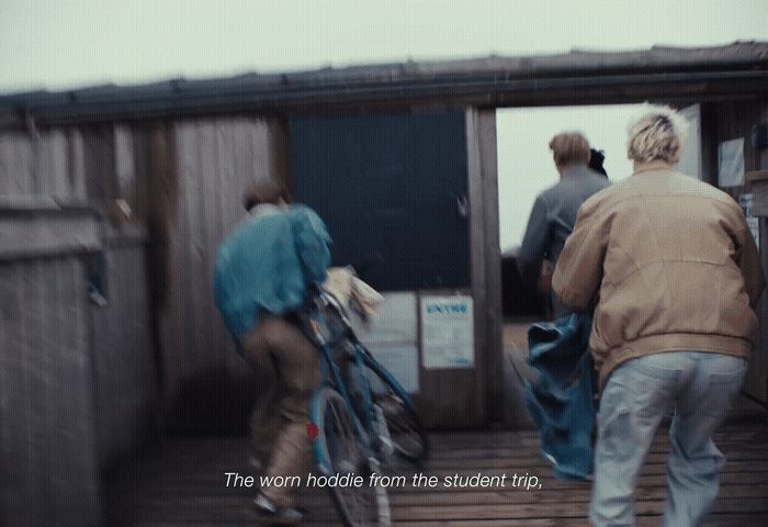 a man riding a bike down a wooden ramp