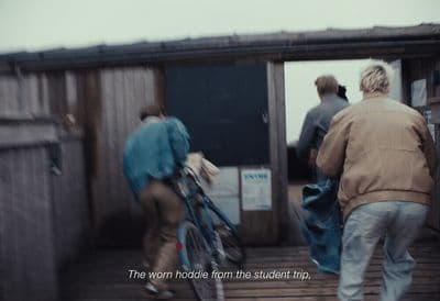 a man riding a bike down a wooden ramp