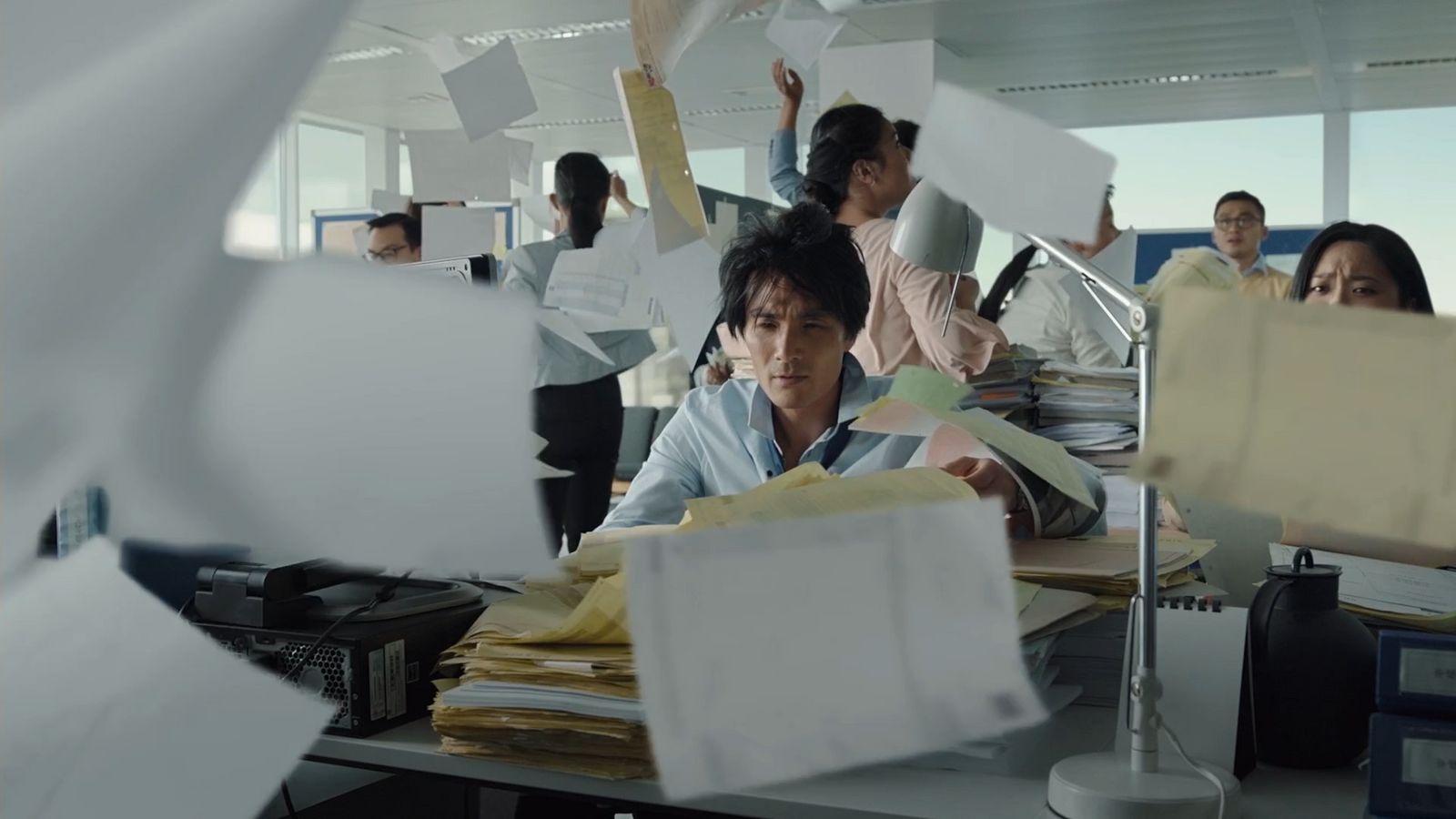 a man sitting at a desk in an office