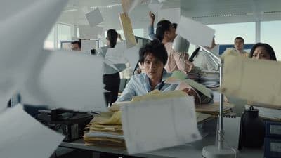 a man sitting at a desk in an office
