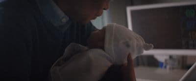 a man holding a baby in his arms
