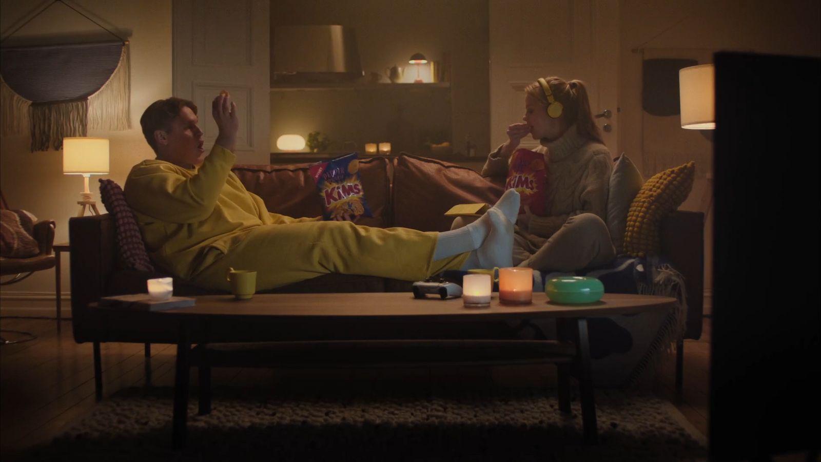 a man and woman sitting on a couch in a living room