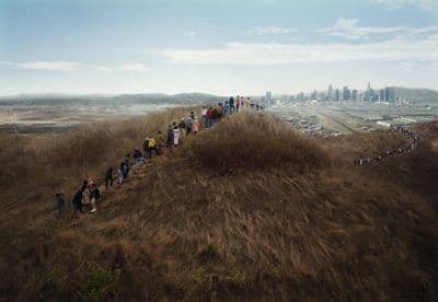 a group of people standing on top of a hill
