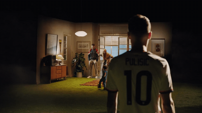 a group of people standing around a living room