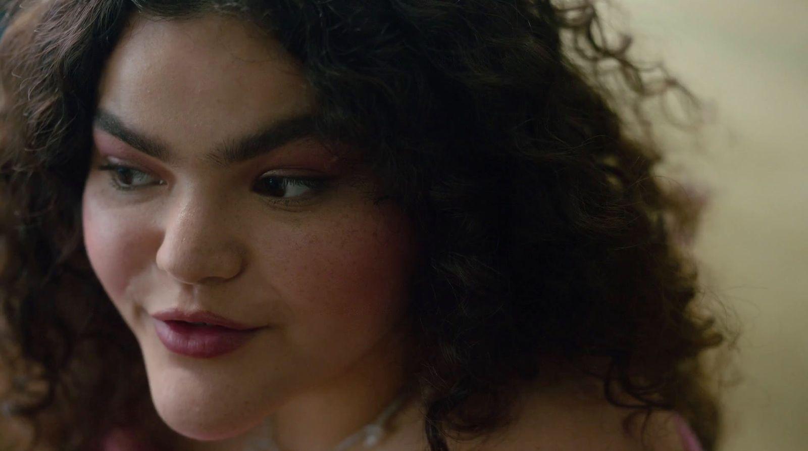 a close up of a woman with curly hair
