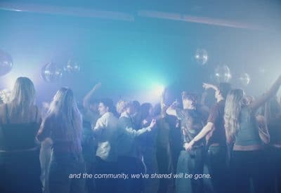 a group of people standing around each other in a room