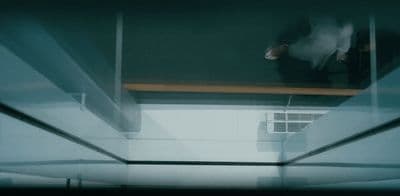 a person standing on a ledge in a room