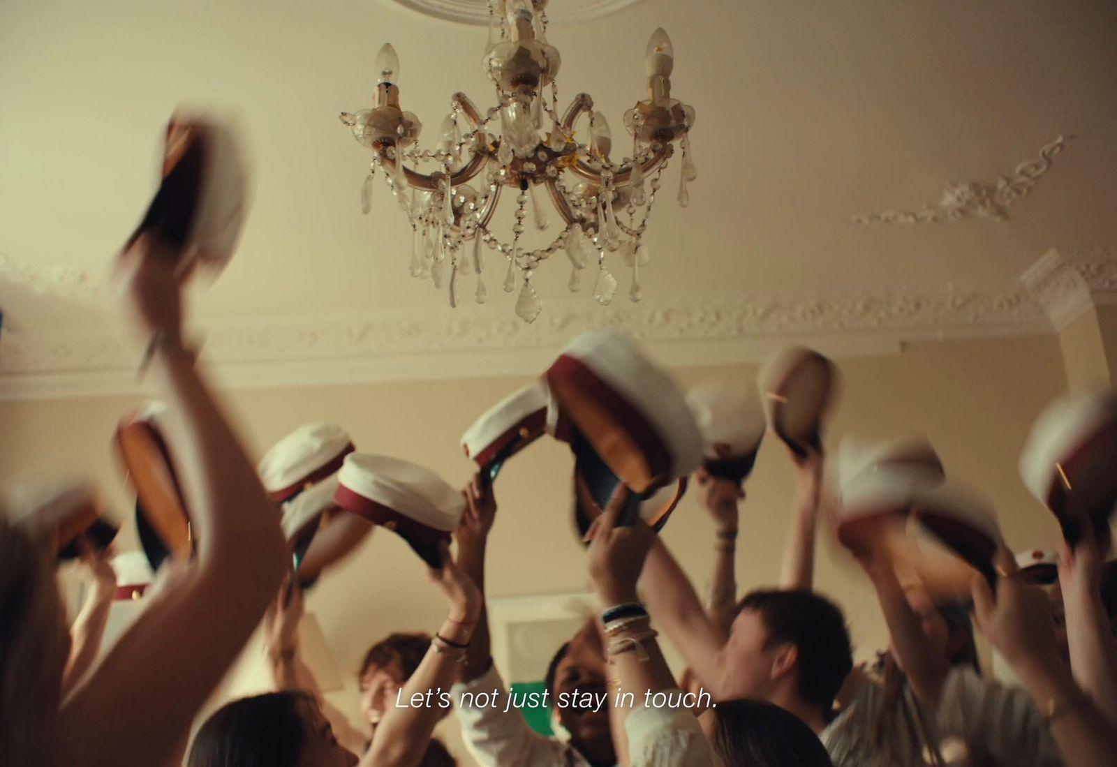 a group of people holding up hats in the air