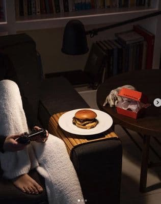 a woman sitting on a couch holding a remote control