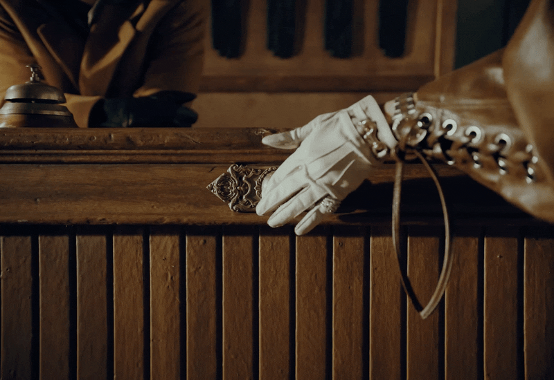 a pair of white gloves sitting on top of a wooden table