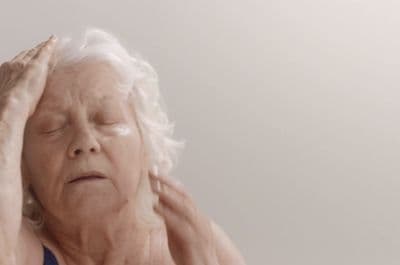 a woman holding her head in her hands