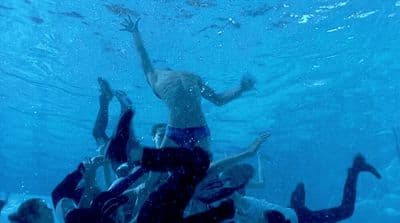 a group of people swimming under water in a pool