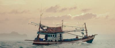 a fishing boat in the middle of the ocean