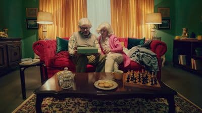 a man and woman sitting on a couch in a living room