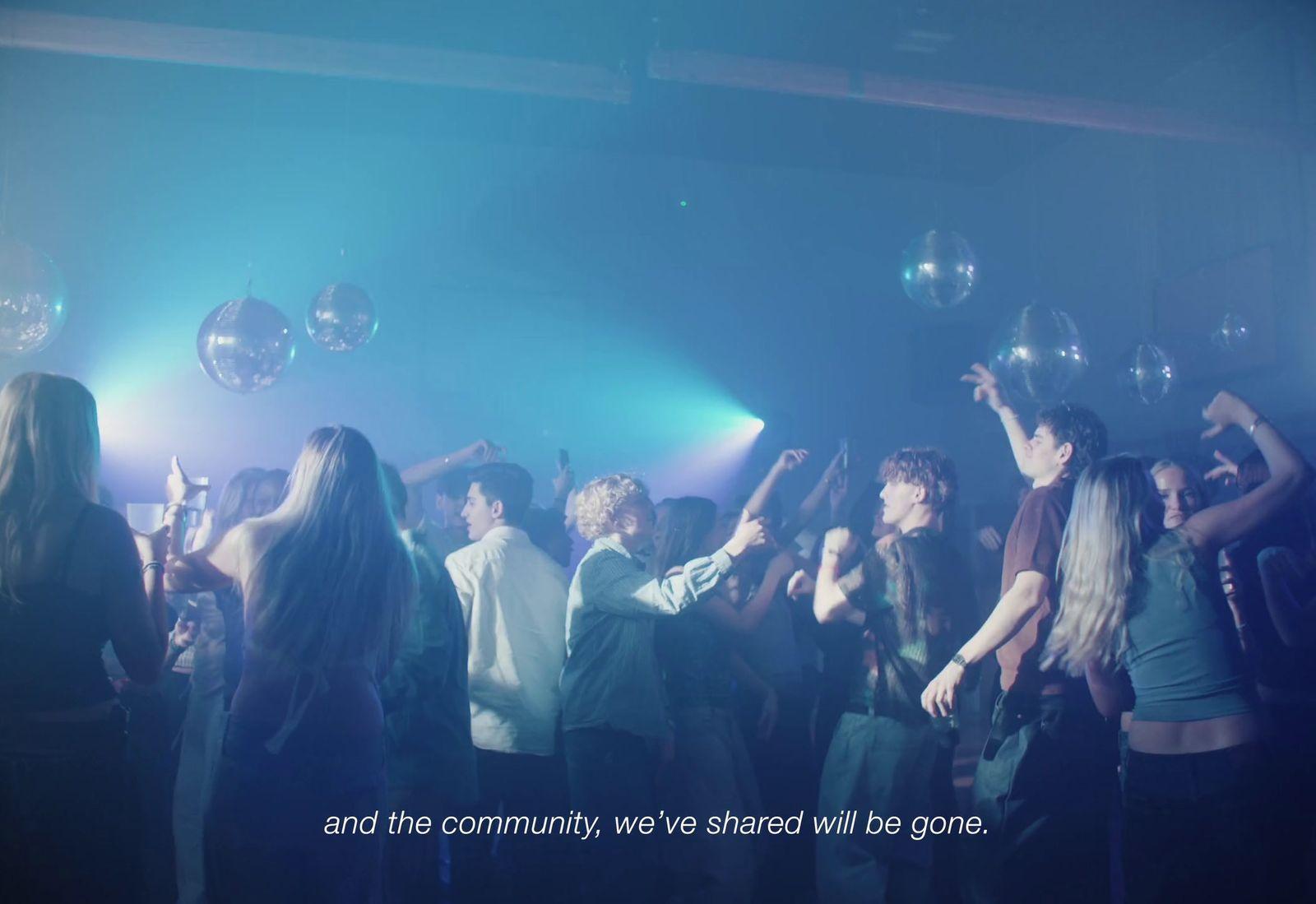 a group of young people dancing in a club