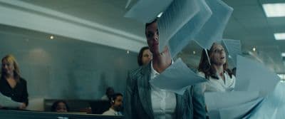 a group of people in a room with papers