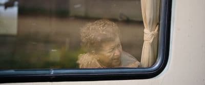a reflection of a woman looking out a window