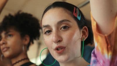 a woman with ear piercings on her nose