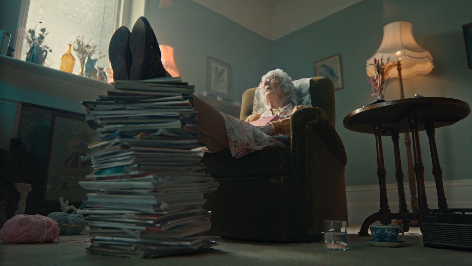 a woman sitting in a chair with a stack of papers