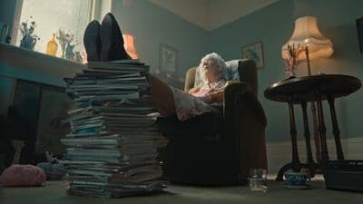 a woman sitting in a chair with a stack of papers