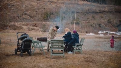 a group of people sitting around a fire pit