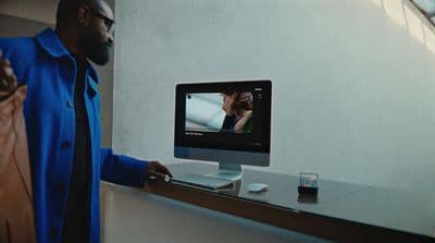 a man standing in front of a computer screen
