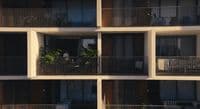 an apartment building with balconies and plants on the balconies