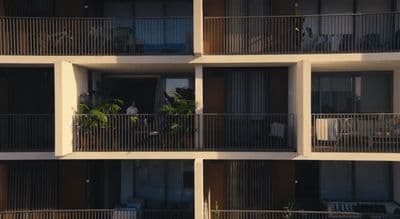 an apartment building with balconies and plants on the balconies