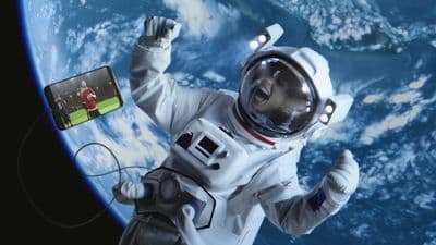 a man in a space suit holding a cell phone