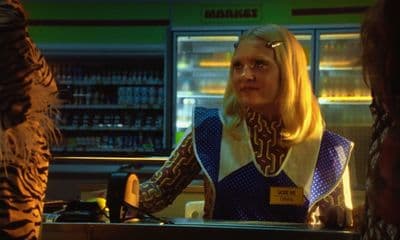 a woman sitting at a counter in a store