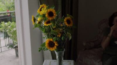 a vase filled with sunflowers sitting on a table
