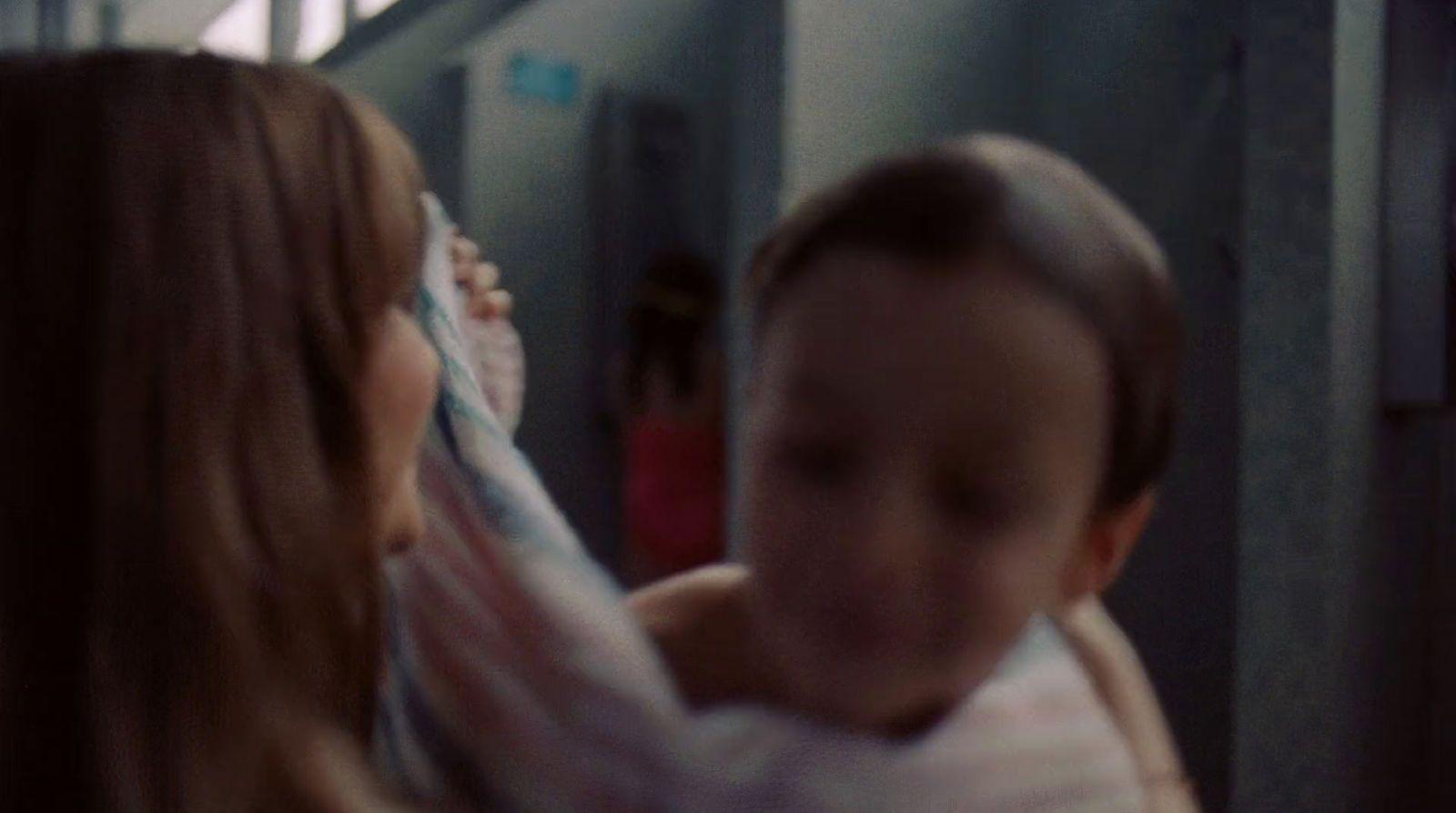 a woman holding a baby in her arms
