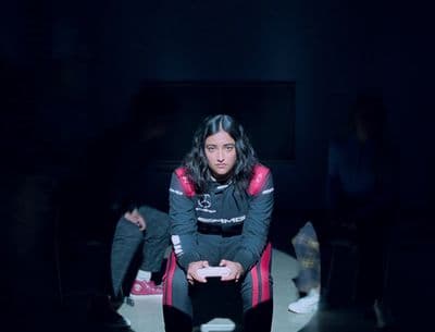 a woman sitting in a chair in a dark room