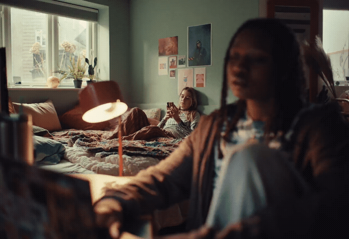 a woman sitting on a bed in a bedroom