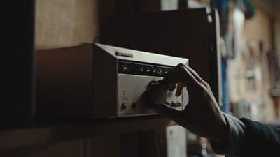a person is pressing buttons on a microwave