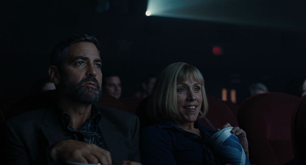 a man and a woman sitting in a movie theater