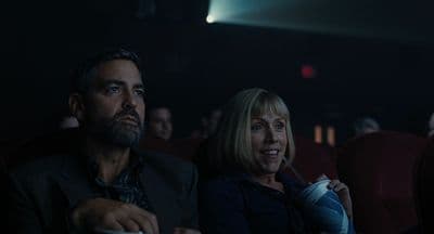 a man and a woman sitting in a movie theater