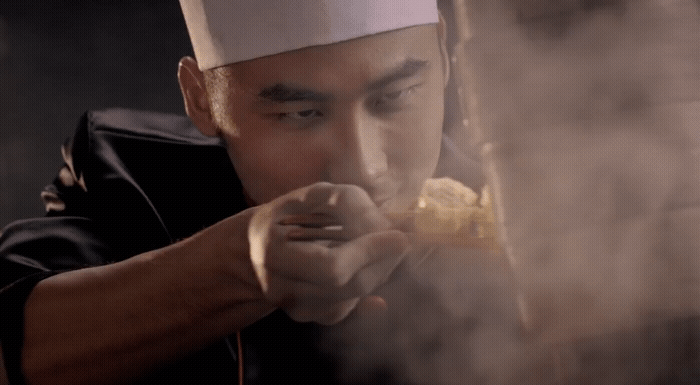 a man in a chef's hat is cooking food