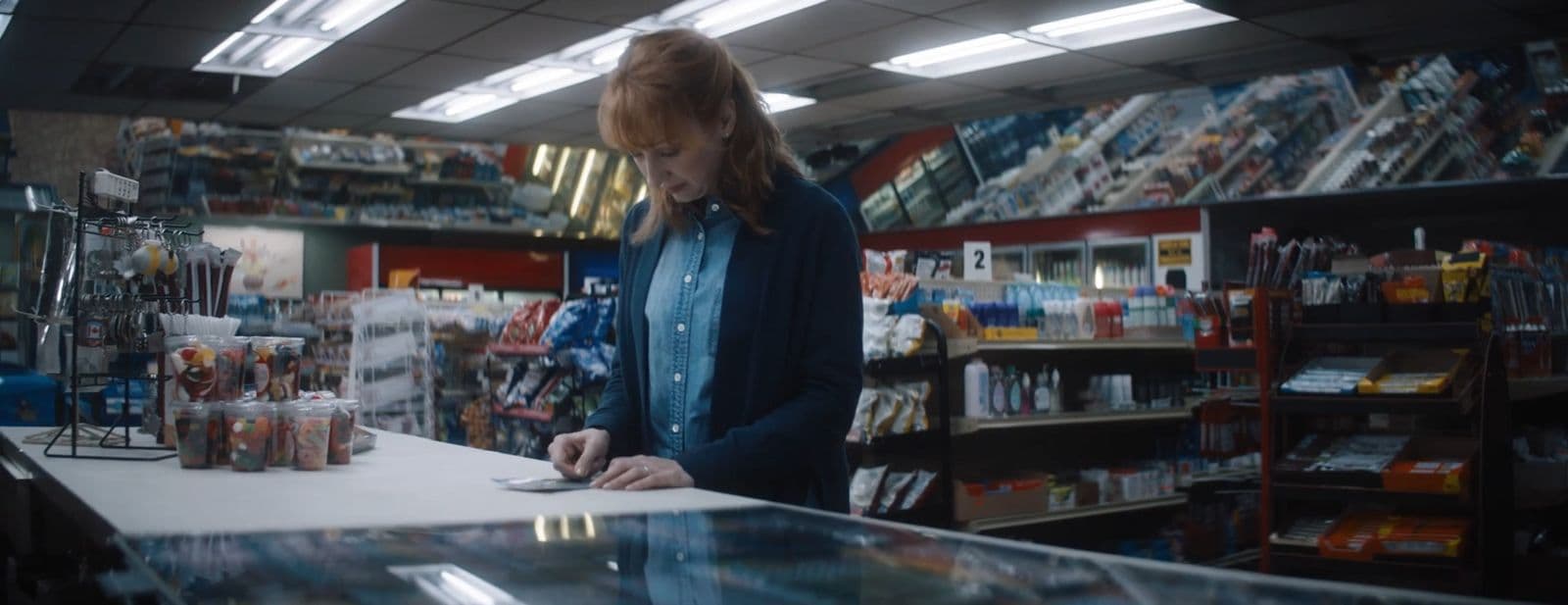 a woman standing at a counter in a store