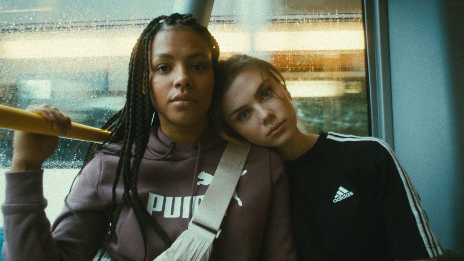 two women sitting next to each other on a train