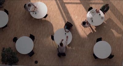 a group of people sitting at tables in a room