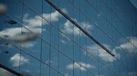 the reflection of a building in the windows of another building