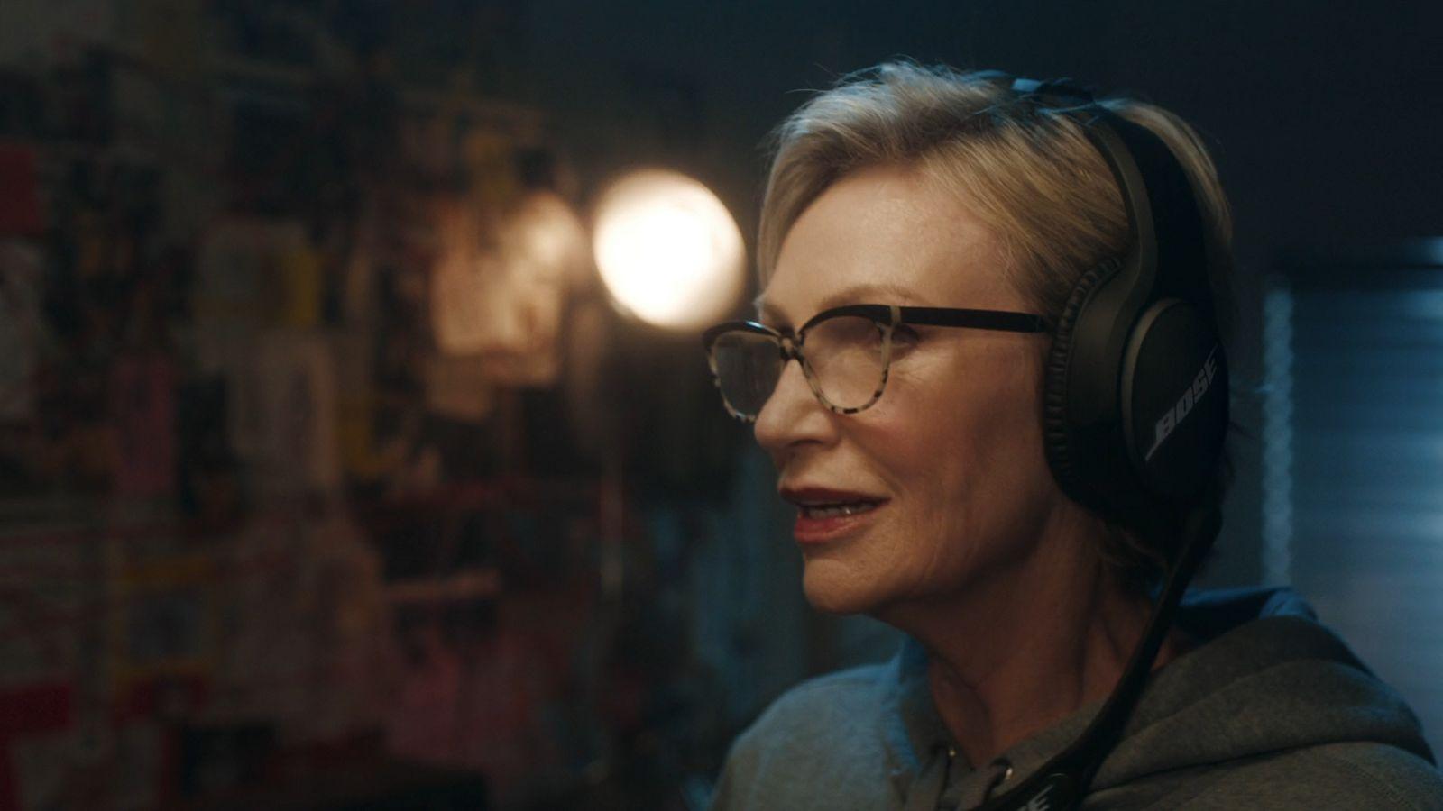 a woman wearing headphones in a dark room